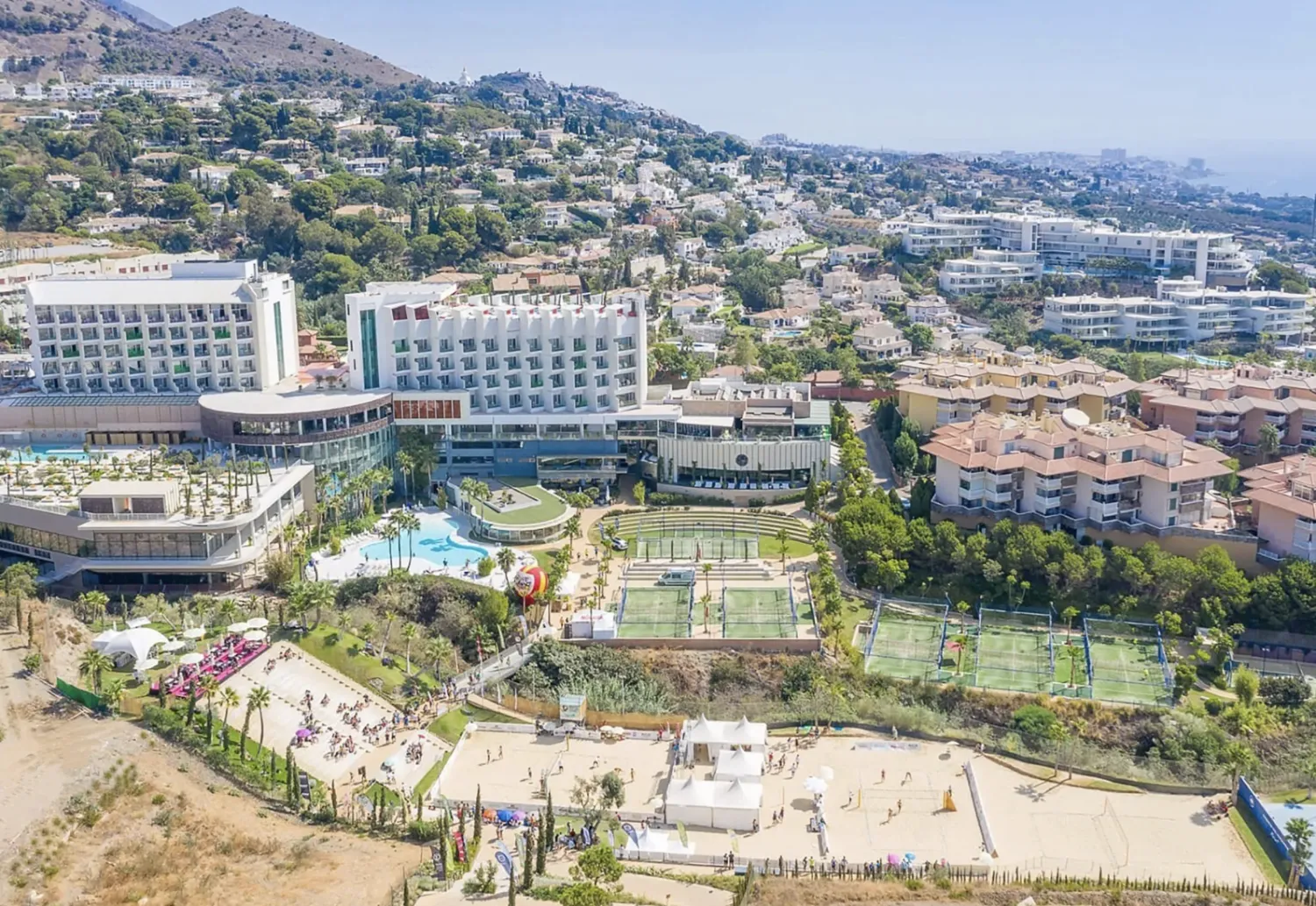 Aerial view of the Higuerón resort complex with hotels, pools, padel courts and hillside apartments
