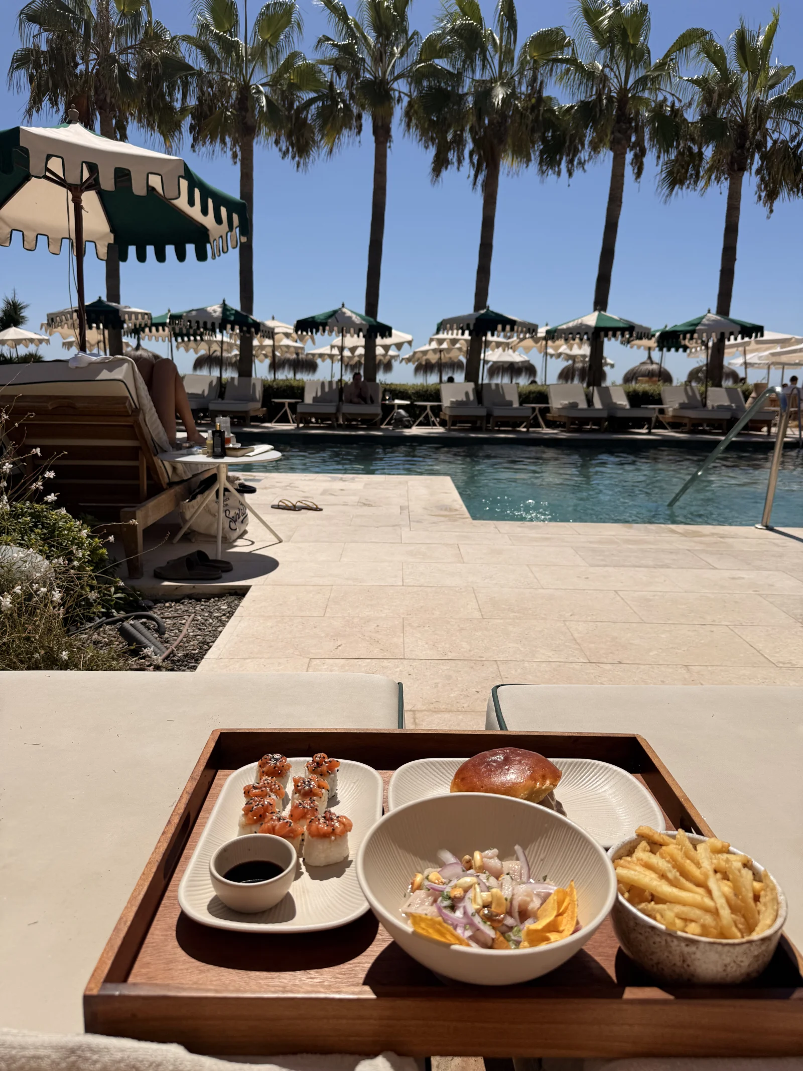 people enjoying food at a pool club in marbella called Barbillon