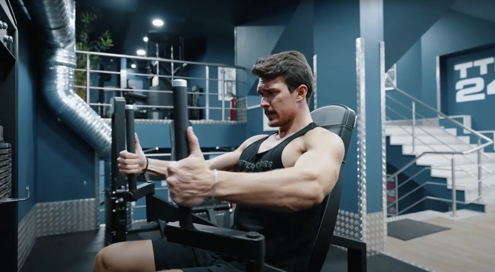 Man training on a chest press machine in a modern gym