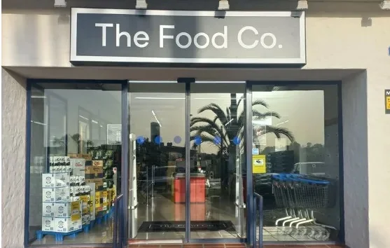 The glass entrance of The Food Co in Puerto Banús