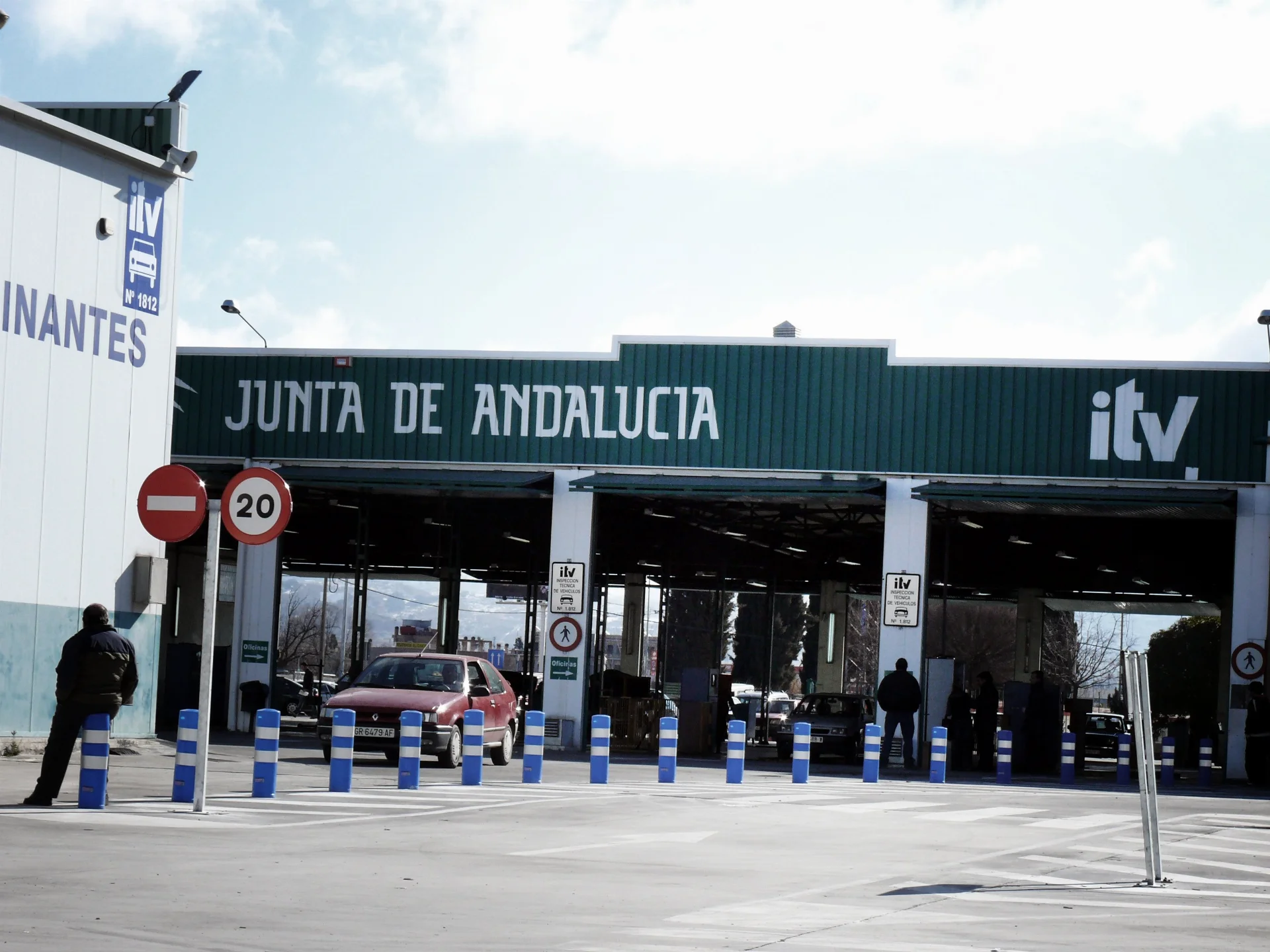 A Junta de Andaluc&iacute;a ITV station in Granada, with the inspection bays open and cars waiting